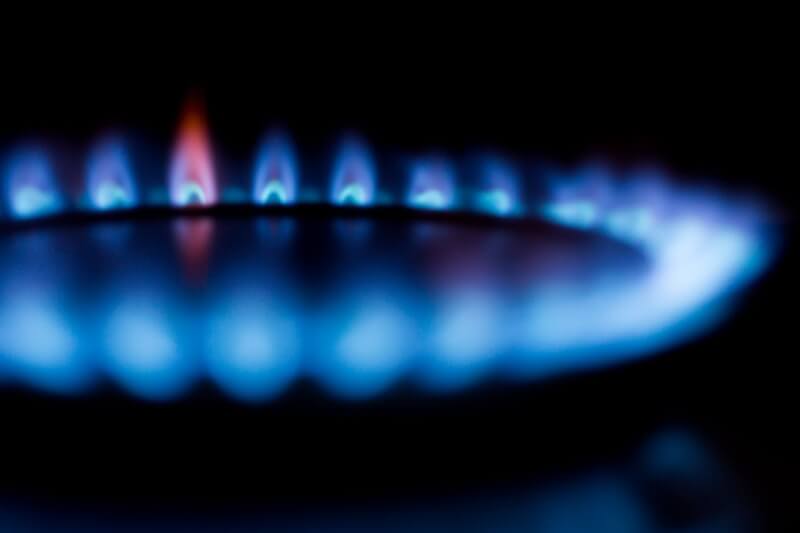 Blurred image of a blue gas stove flame, highlighting heat and energy.